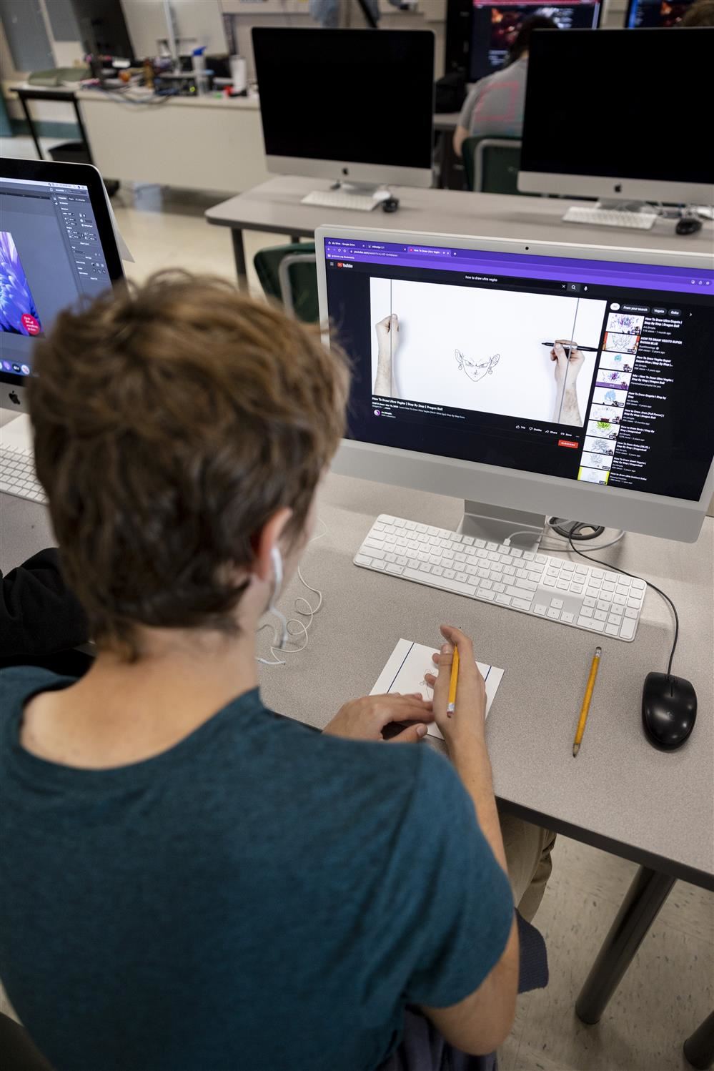 Graphic Arts student drawing on a computer